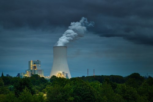 Chimney smoke against a dark sky